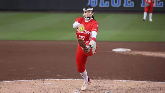 Kasey Ricard is in the middle of her pitching motion as she releases a pitch toward home plate