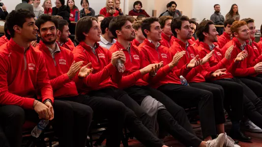 Men's ice hockey players clapping during NCAA Selection Show