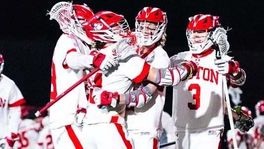 Men's lacrosse players celebrating a goal