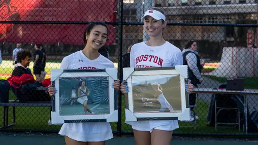Victoria Carlsten and Kaitlin Tan holding their senior day photo frames