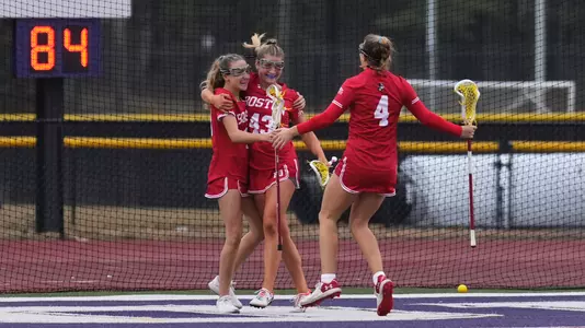 Women's lacrosse celebrates a goal at Stonehill