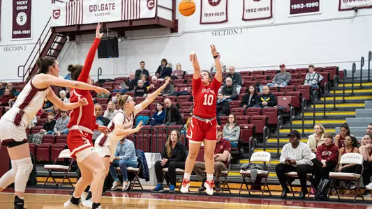 Photo of women's basketball junior Alex Giannaros shooting a three-pointer at Colgate.