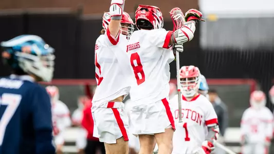 Vince D'Alto and Louis Perfetto jump in celebration after a goal against Bucknell