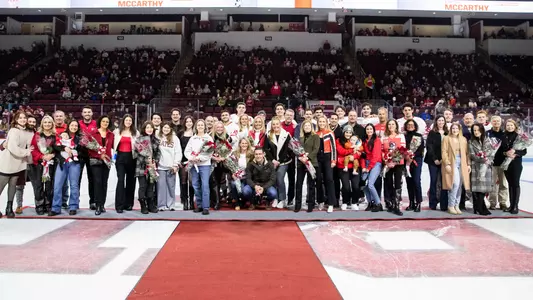 The BU men's ice hockey Class of 2024 poses for a group photo after the Senior Day ceremony