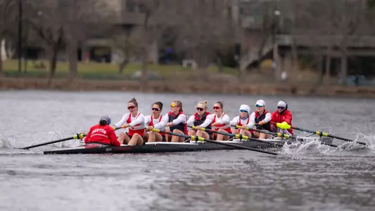 Photo of the Women's Rowing 2V8 racing Northeastern, Harvard, and Dartmouth.