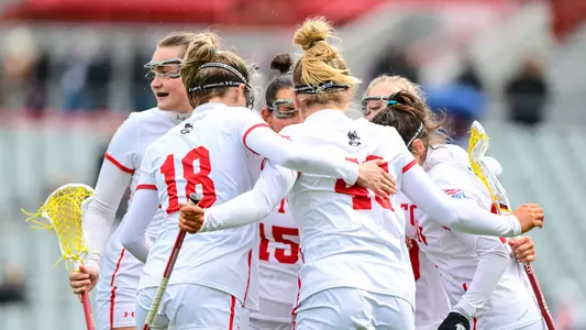 Women's Lacrosse huddles after a goal