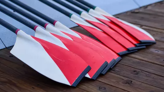 Photo of BU Rowing oars on the DeWolfe Boathouse dock.
