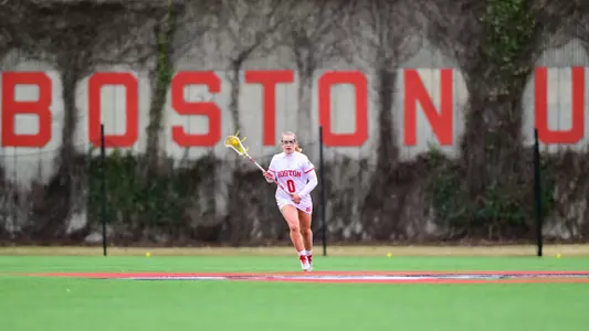 Ellen Monahan runs with the ball at lacrosse