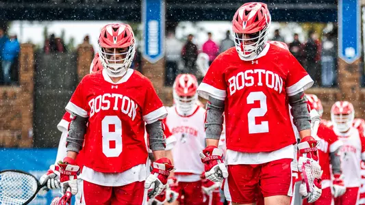Louis Perfetto and Thomas Niedringhaus walking out to the field in the rain