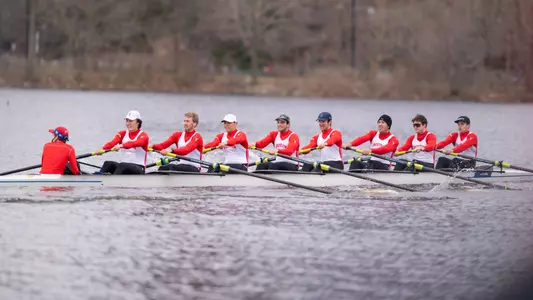 Photo of the Men's Rowing 4V8 racing against Northeastern on the Charles River.