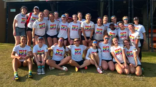 Photo of the Women's Rowing team in BU Pride t-shirts at the Lake Wheeler Invite.