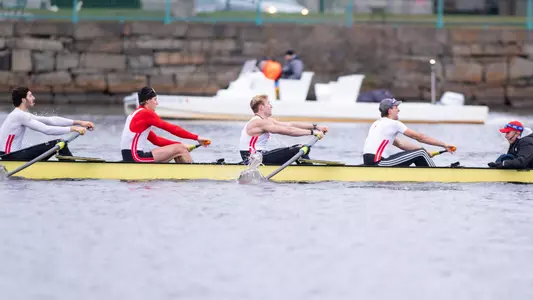 Photo of the Men's Rowing Varsity 8 competing on the Charles River.