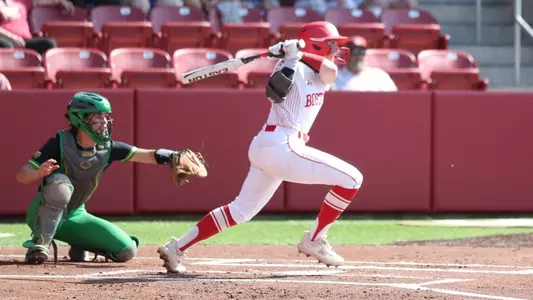 Caitlin Coker hits a single up the middle against Oregon