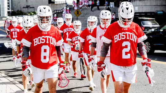BU men's lacrosse players walking out to field at Army