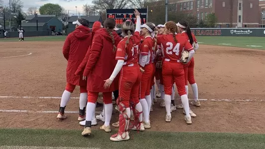 BU softball team huddle after earning 11-0 (5) win at Boston College