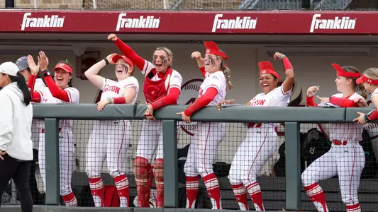 Boston University softball dugout celebrate after run scored
