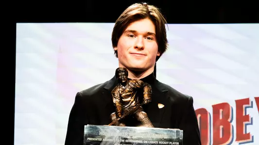 Macklin Celebrini holding the Hobey Baker Award