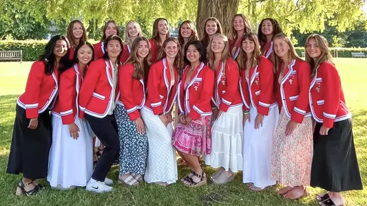 Photo of the BU Lightweight Rowing team in their red Henley blazers at the Henley Women's Regatta.
