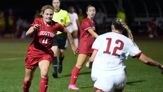 Photo of women's soccer senior Erin Sullenberger dribbling the ball against Northeastern in 2023.