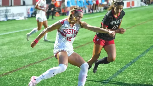 Photo of women's soccer freshman Jaiden Schultz crossing the ball from the corner in a game vs. Northeastern.