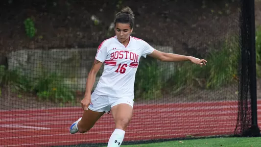 Photo of women's soccer junior Shayla Brown inserting a corner kick in a game at Nickerson Field.