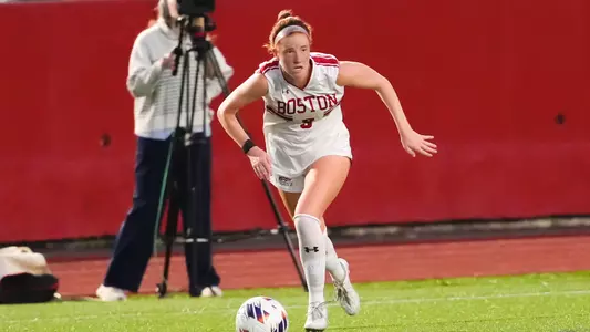Photo of women's soccer junior Margy Porta dribbling the ball at Nickerson Field.