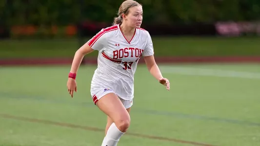 Photo of women's soccer freshman Maddie Green playing soccer at Nickerson Field.