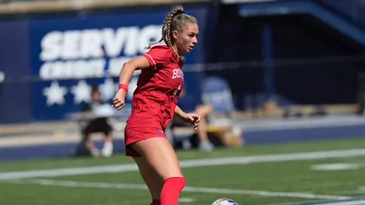 Photo of women's soccer junior Mackenzie Stickelman dribbling the ball at UNH.