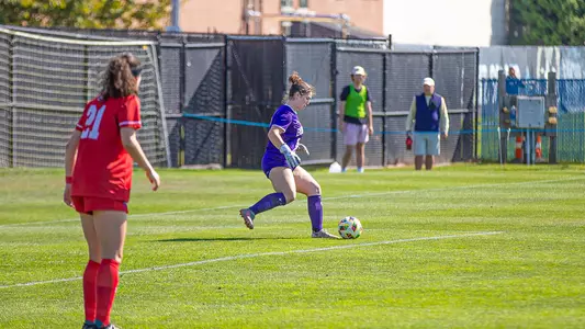 Photo of women's soccer freshman Bridget Carr kicking the ball at Rhode Island.