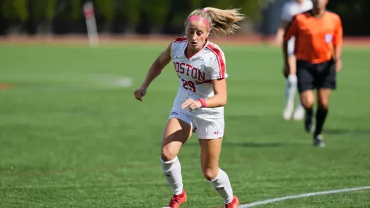 Photo of women's soccer senior Morgan Fagan about to shoot the ball at Nickerson Field.