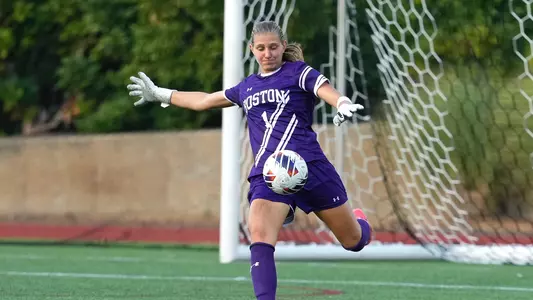 Photo of women's soccer goalkeeper Celia Braun clearing the ball during a game at Nickerson Field.