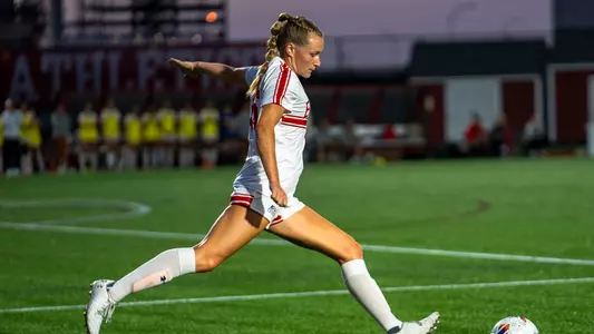 Photo of women's soccer senior Allison Hanlon setting up a free kick at Nickerson Field.
