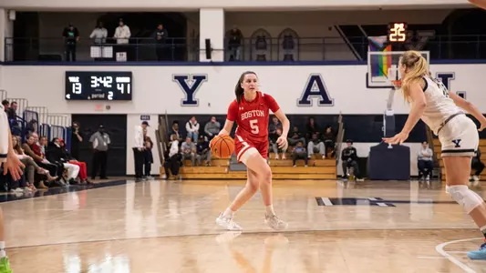Photo of women's basketball sophomore Aoibhe Gormley passing the ball at Yale.