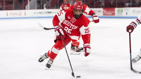 Ani FitzGerald skating with the puck against Harvard at the Beanpot