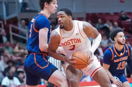Malcolm Chimezie playing basketball against Bucknell