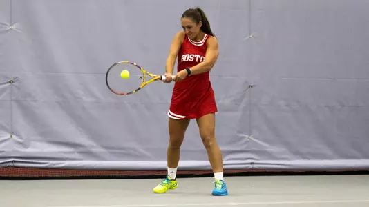 Gabriella Mikaul hits a forehand shot on an indoor tennis court