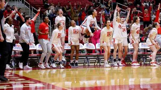 Photo of the BU Women's Basketball bench celebrating at Case Gym.
