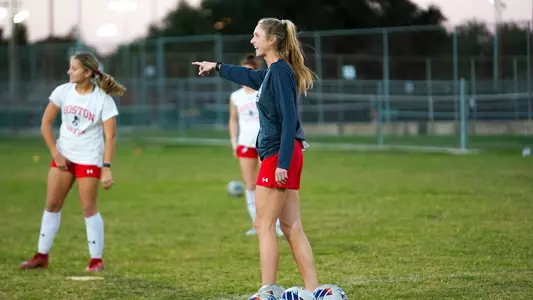 Photo of women's soccer coach Megan Burke giving out directions during a practice in Texas.