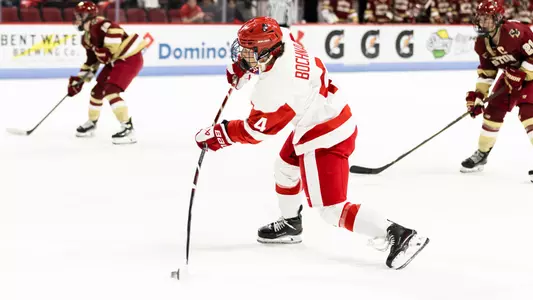 Lindsay Bochna shooting the puck at home against BC