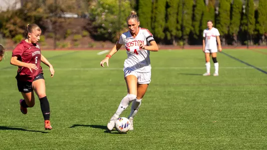 Photo of BU women's soccer senior Mackenzie Stickelman dribbling the ball at Nickerson Field.