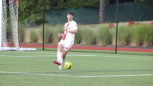 John Roman kicks the ball up the field