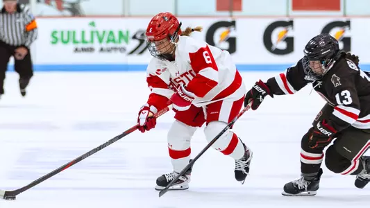 Kate Meinert skates with the puck against Brown