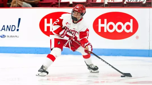 Lexie Bertelsen playing hockey about to pass the puck