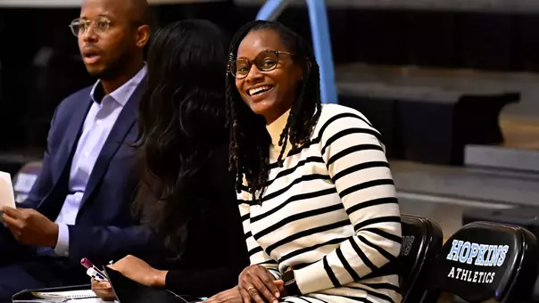 Photo of Moneshia Davis smiling while sitting on the bench at Johns Hopkins
