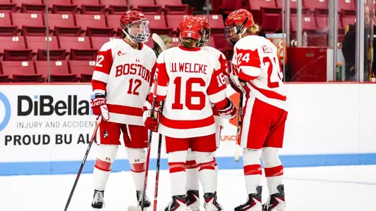 Women's Ice Hockey in game huddle