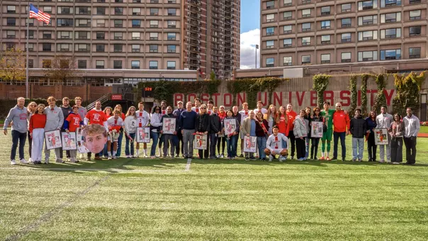 Men's soccer seniors pose for a group photo with family in attendance.