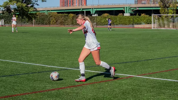 Photo of women's soccer freshman Averie Hoff about to kick the ball at Nickerson Field.