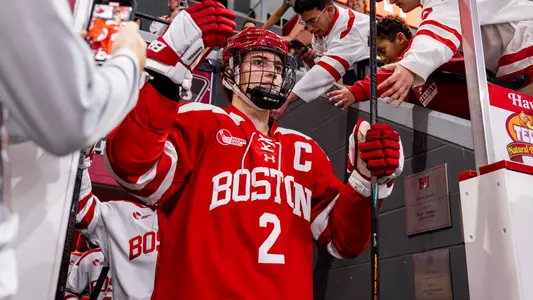Gavin McCarthy high-fives fans as he takes the ice at Agganis Arena