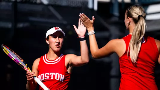Women's tennis high five after a point