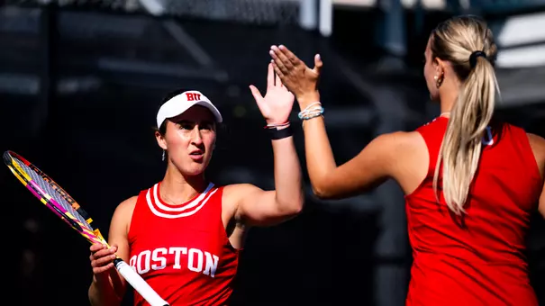 Women's tennis high five after a point